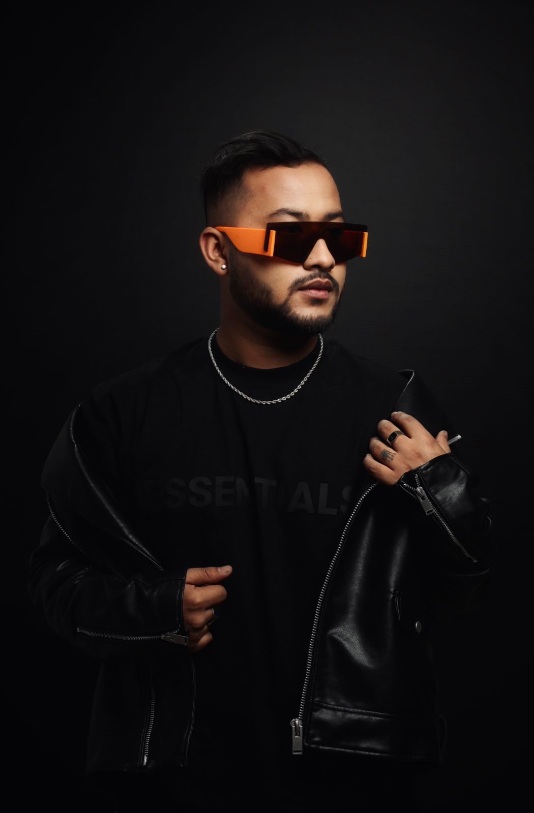 DJ Nihan studio portrait, orange shades and leather jacket